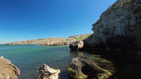 showcases the serene beauty of the sea gently embracing rocky formations