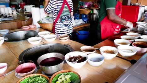 two people preparing noodle dishes together