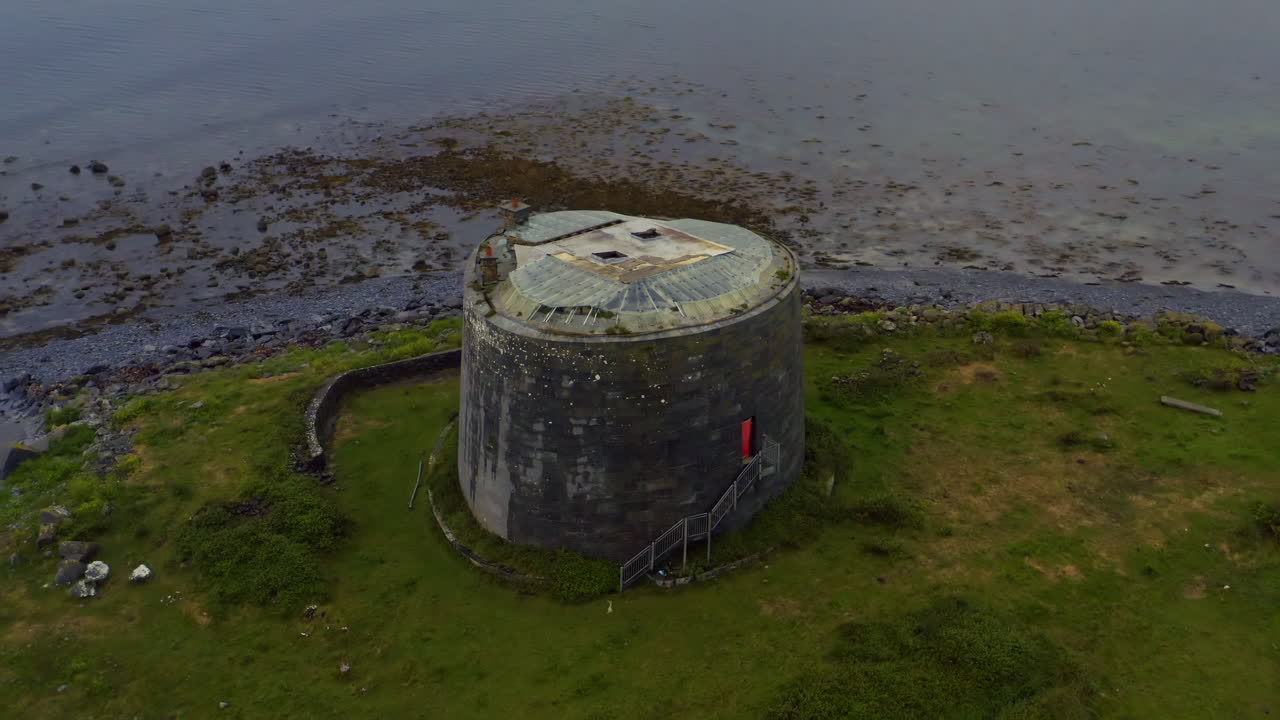 Dynamic aerial orbits around Aughinish Martello Tower, built in anticipation of a Napoleonic invasion that never came, revealing the surrounding Atlantic Ocean