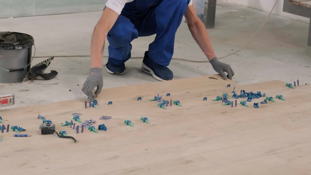 Installing ceramic floor tiles - measuring and cutting the pieces. Construction, renovation, repair apartment. Cuts tile. Tile cutting