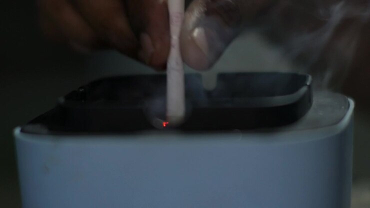 Person Extinguishing a Cigarette in an Ashtray