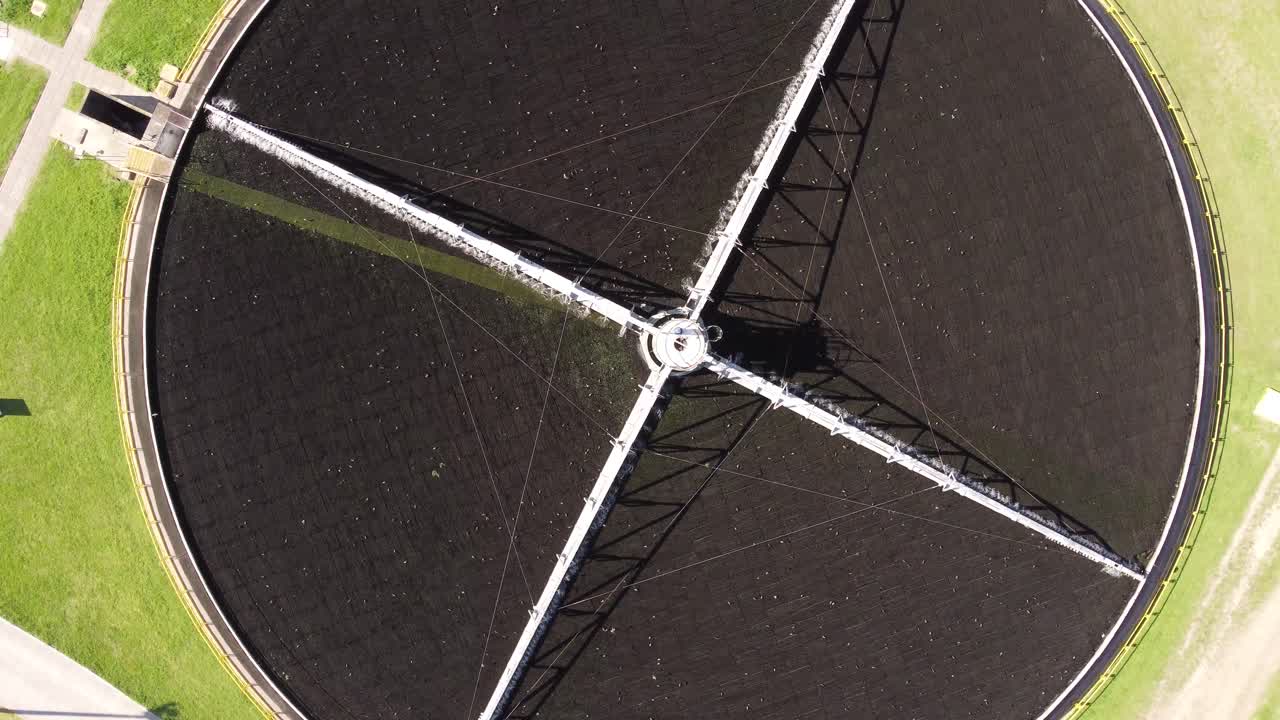 Drone top down showing pool filters clean water in Water Purification Plant during sunlight - Birds flying around