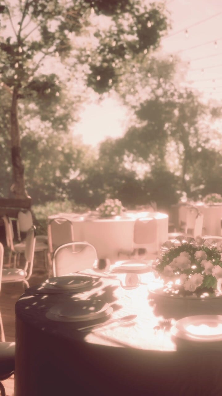 Tables are set for an outdoor gathering with flowers in the center