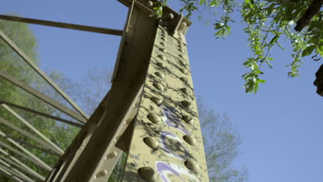 a slider move across the bridge posts. graffitys are covering the bridge.