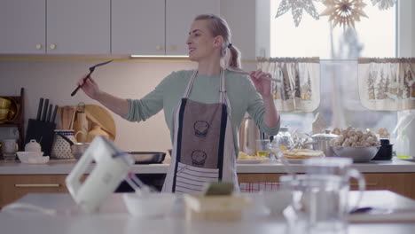 happy woman dancing in kitchen