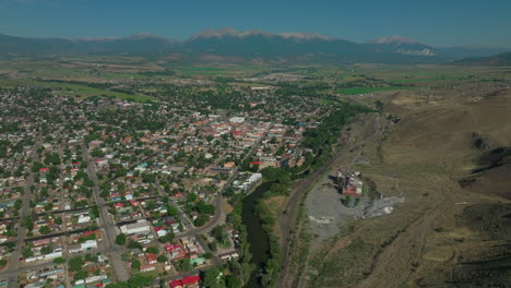 Aerial-cinematic-drone-mid-summer-downtown-Salida-S-Lime-Mill-Colorado-near-Buena-Vista-on-Arkansas-River-Riverside-Park-Scout-surfing-wave-biking-hiking-rafting-Rocky-Mountain-up-high-forward-pan-up