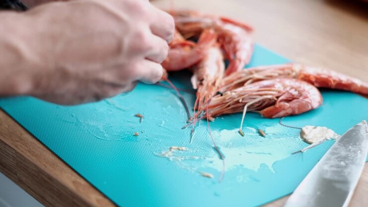 Man Peeling Shrimp: Slow-Motion on Blue Board Prawn Cleaning for Cooking