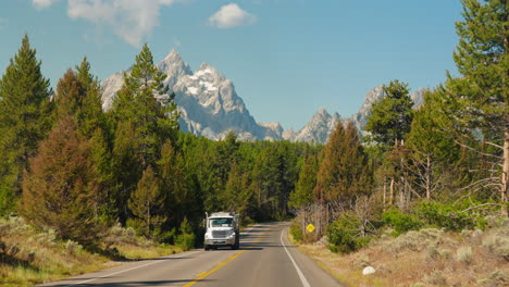 rv on a scenic road through grand teton national park