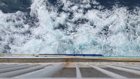 the view over the side of a ship as it sails through the ocean