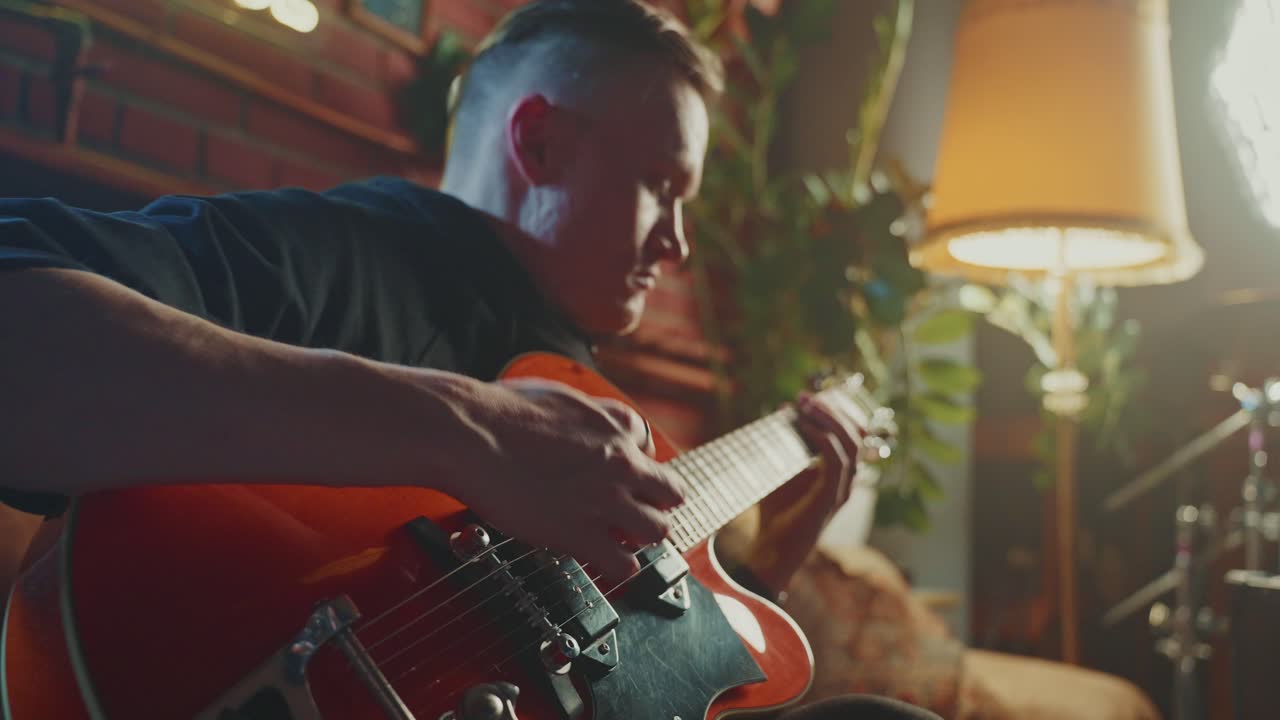 Man Playing Guitar at Home