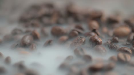 close-up of hot coffee beans with smoke rises above