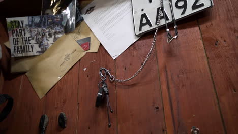 motorcycle accessories and documents on a wooden wall