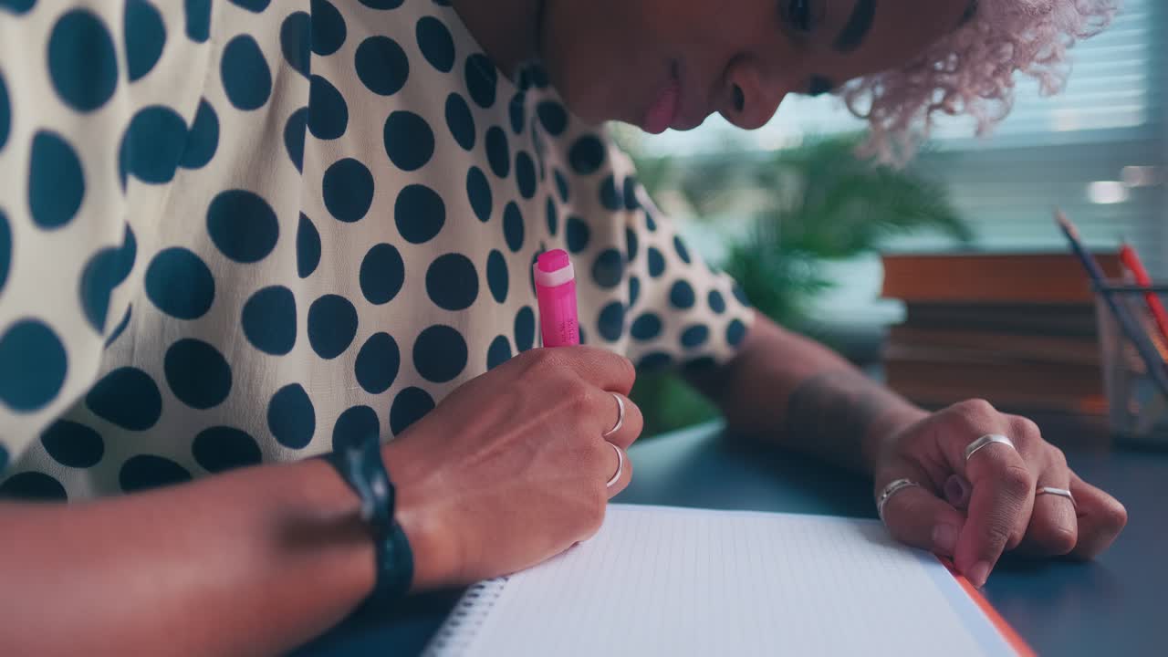 Serious woman in notebook draws line up which symbolizes achievement of goals