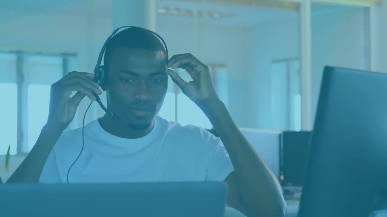 Animation of red particles moving over african american man talking on phone headset
