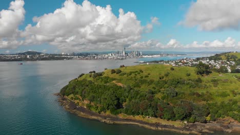 Flying-over-North-Head-towards-Auckland,-New-Zealand