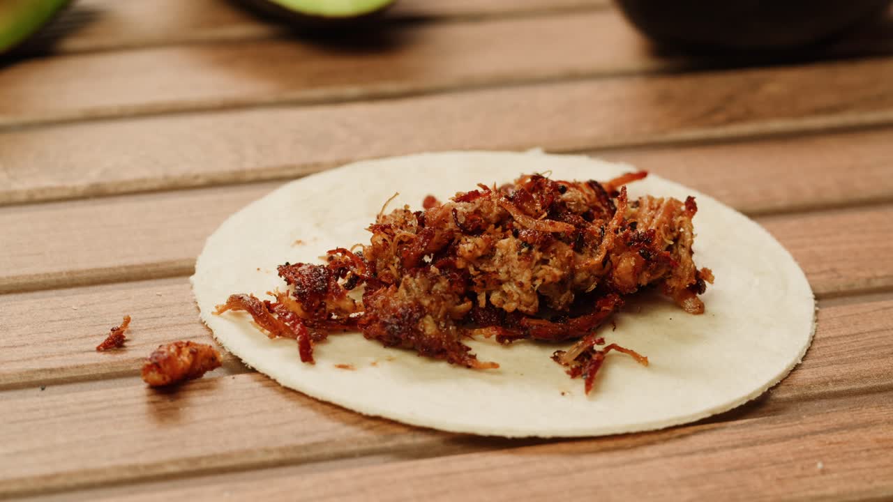 Preparing a Delicious Taco with Shredded Pork