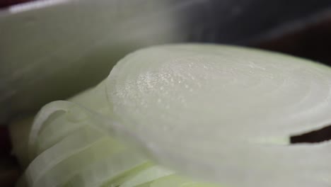 close up of cut white onion rings on marble top