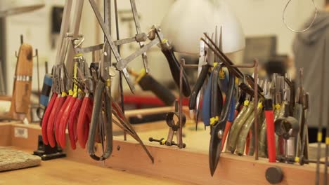 Close-up-of-work-room-full-of-pliers,-tweezers,-splitters,-files-and-other-tools