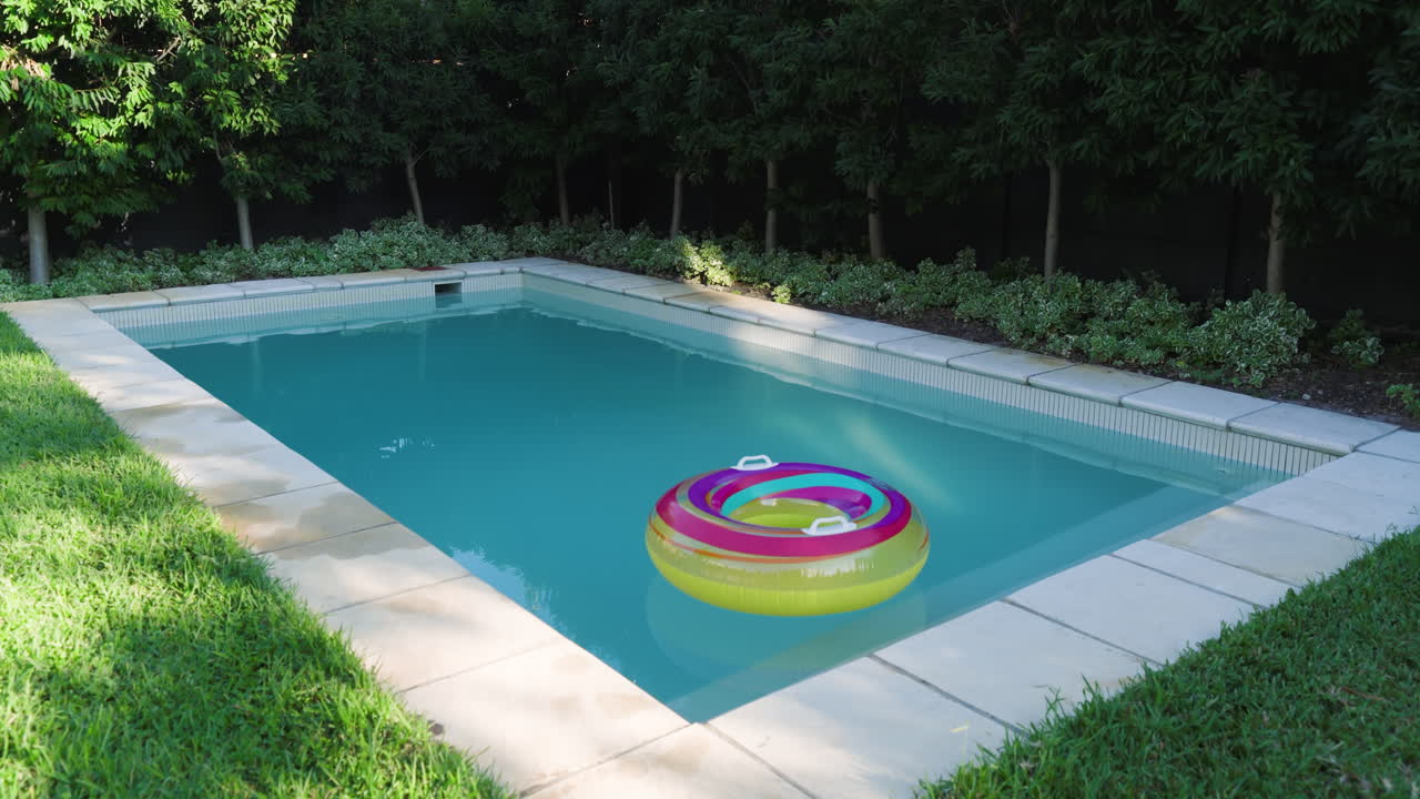 Colorful inflatable ring floating in serene backyard pool surrounded by greenery, copy space