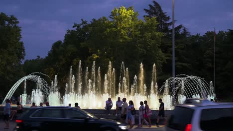 evening scene at fuente de reloj in plaza de zorrilla, valladolid, spain, with glowing water and visitors relaxing by the fountain in spain.