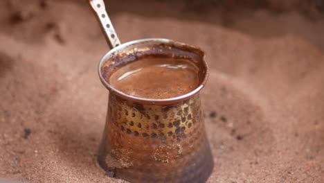 turkish coffee brewing in the sand