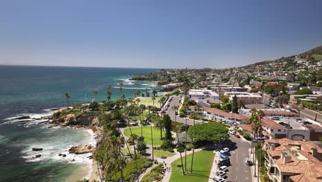 Volando-Sobre-El-Parque-Heisler-En-Laguna-Beach-California-Vista-Aérea-Del-Parque,-Océano-Pacífico,-Acantilados,-Rocas,-Palmeras-Y-Grandes-Olas