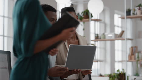 african american team leader woman brainstorming with businessman colleague using laptop computer showing ideas pointing at screen working together in office