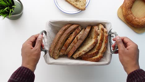 person holding a basket of sliced bread