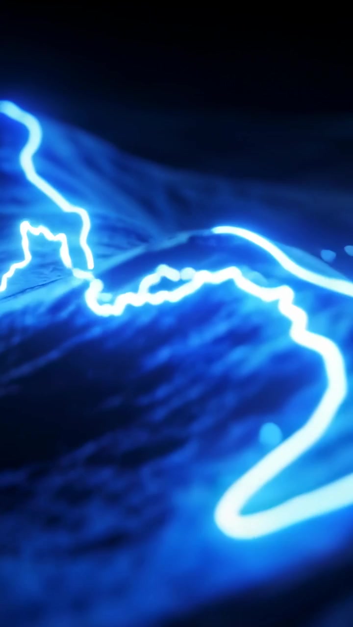 Vidéo verticale: Ligne néon sinueuse partant de la gauche traçant une surface ondulée éclairant les crêtes avec des étincelles