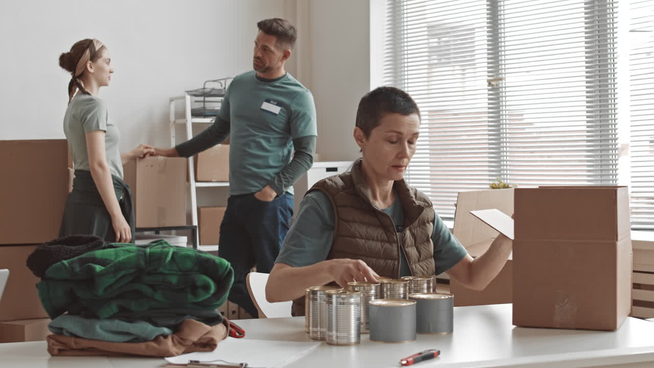 Volunteers Packing Food and Clothing Donations