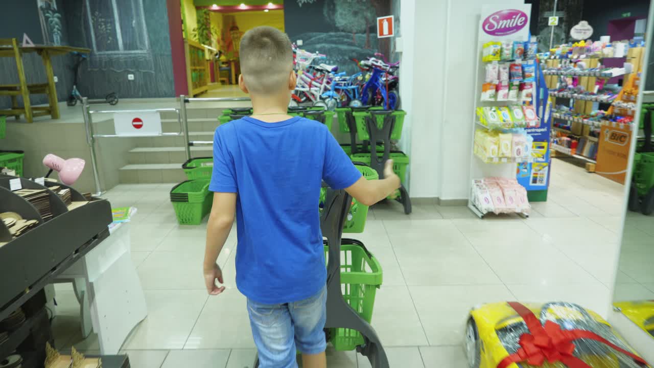 VINNITSA, UKRAINE - AUGUST 20, 2018: Back to School. Boy choosing school stationery at the supermarket.
