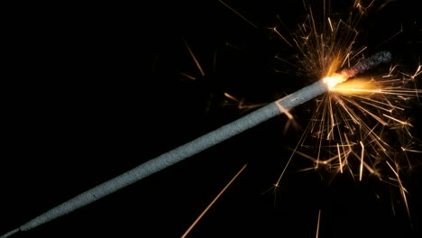 christian sparklers, bengal lights on black background. firework sparkler burning on dark background. closeup