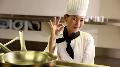 Happy-chef-smiling-at-camera-from-behind-a-shelf