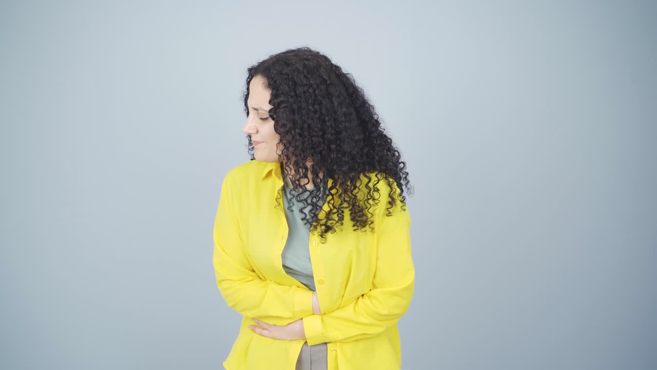 Young woman experiencing stomachache.