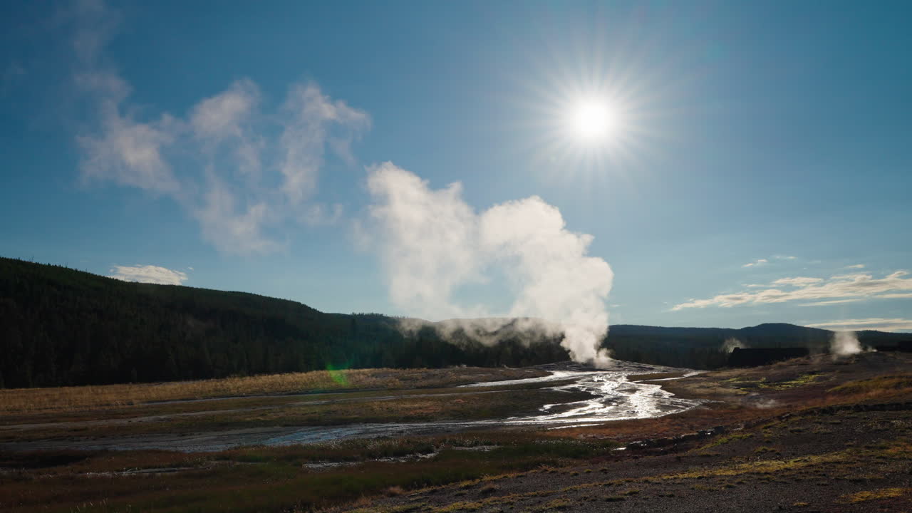 Steaming Geothermal Landscape with River and Sun