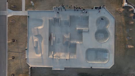 aerial top down shot of skate park, people socialising and skateboarding