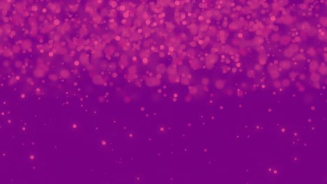 manchas rosadas brillantes que se mueven contra un fondo púrpura