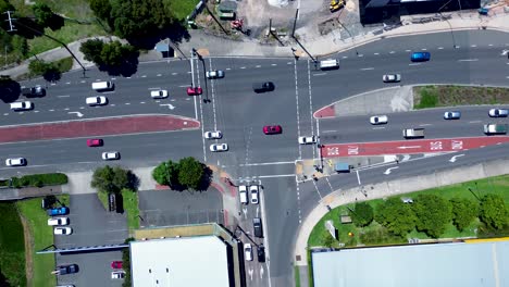 Drone aerial landscape of car vehicles traffic transport at stoplight intersection of Tuggerah main road street Central Coast Australia urban infrastructure travel tourism neighbourhood