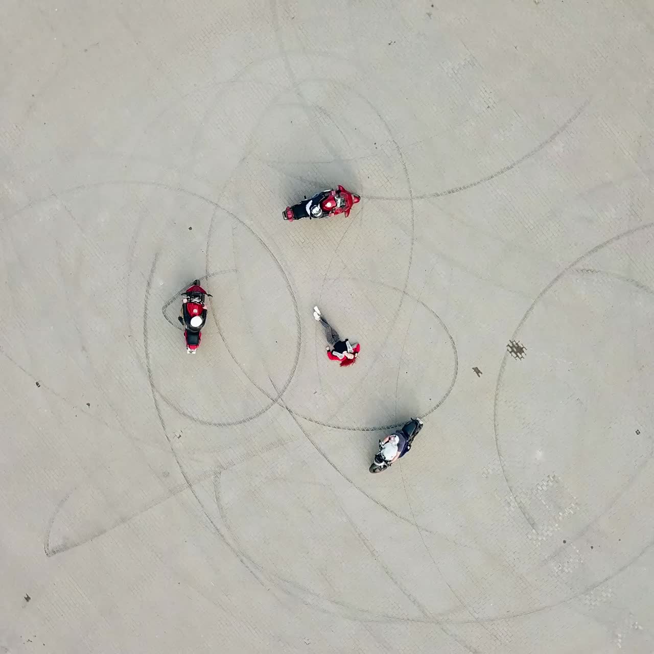 Motorbikers riding around woman