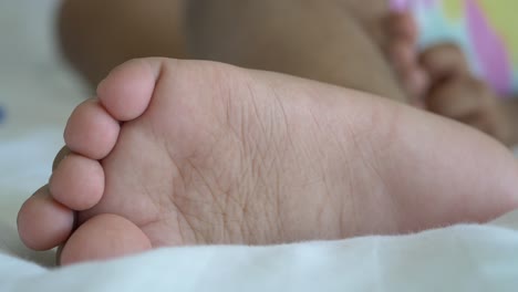 close-up of a baby's foot on a white bed