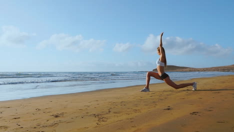 Woman-doing-leg-stretches.-Fitness-girl-stretching-legs-on-beach-training.-SLOW-MOTION-STEADICAM