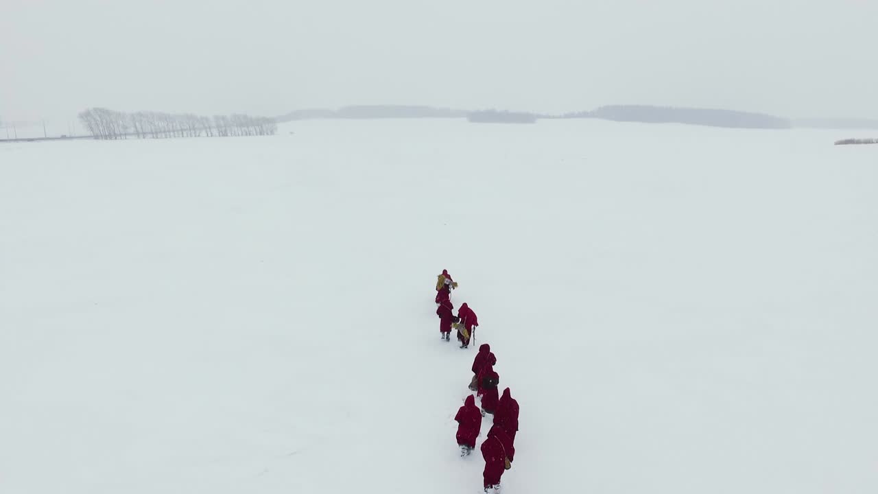 Monks Walking Through a Snowy Field