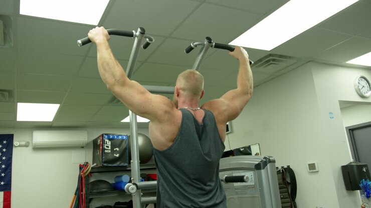Strong bodybuilder lifting weights. Athletic person effort