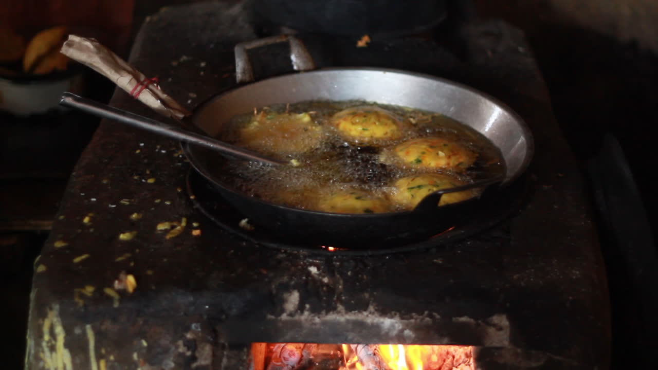 a grandmother cooks typical Indonesian snacks in a traditional kitchen. cook the traditional way using firewood