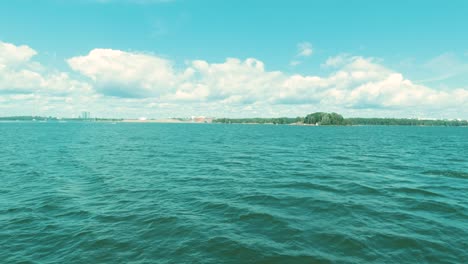 Scenic Ocean Views From a Boat Trip Along Finland's Shoreline on a Summer's Day with Cumulus Clouds on the Horizon.
