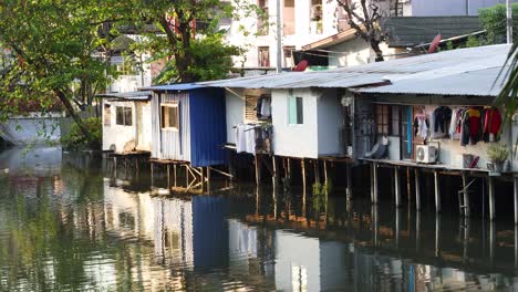 houses on stilts by a canal