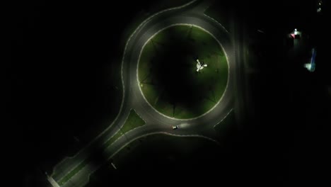 spin moving aerial footage of illuminated roundabout in the night