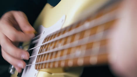 delighted bassist plays white guitar with yellow pick