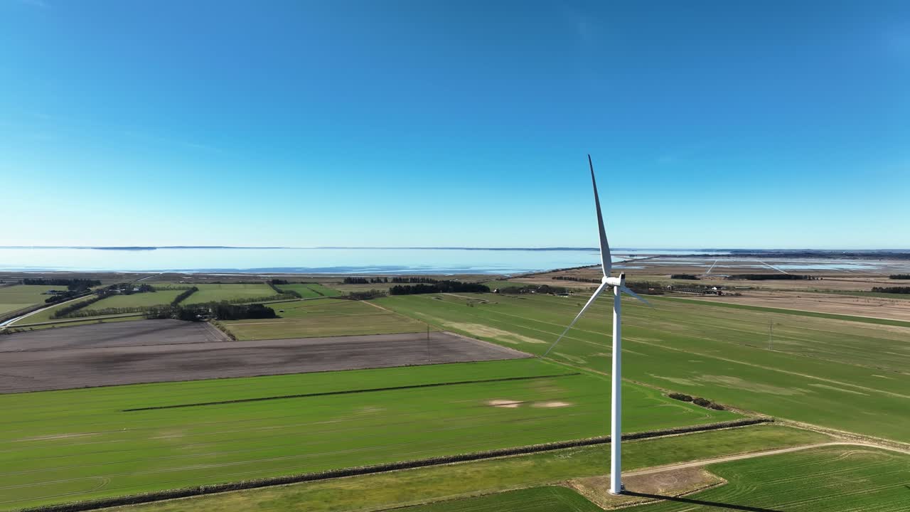 The panoramic view of windmill standing in the fields during spring is a picturesque scene.