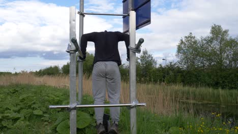 Rear-View-Of-Man-Doing-The-Triceps-Exercise-On-DIY-Bar-When-The-Gyms-Are-Closed-Due-To-Pandemic-In-Dublin,-Ireland---static-shot